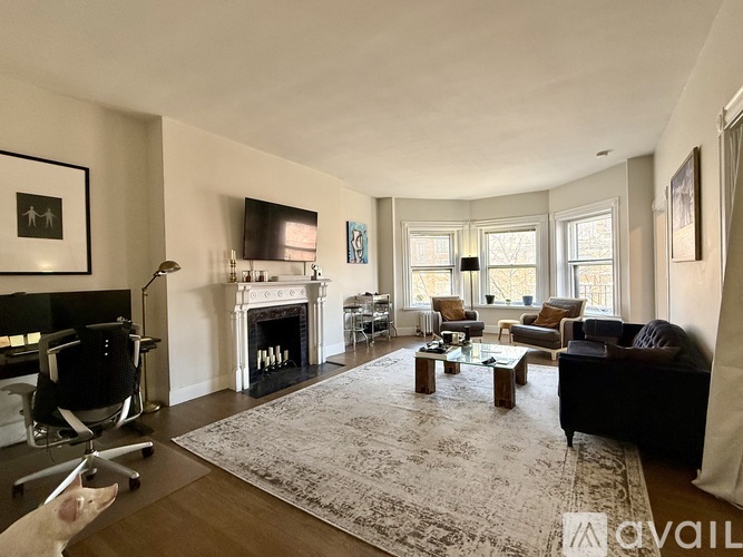 A kitchen with white cabinets and a stainless steel refrigerator.