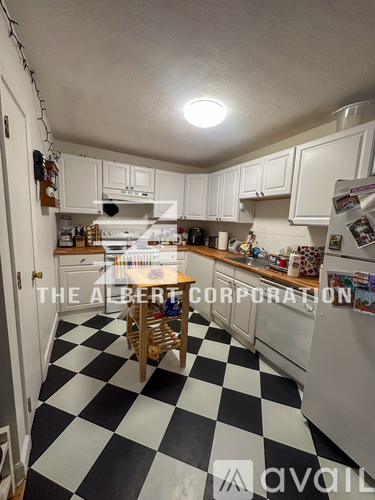 A kitchen with black and white checkered floor.