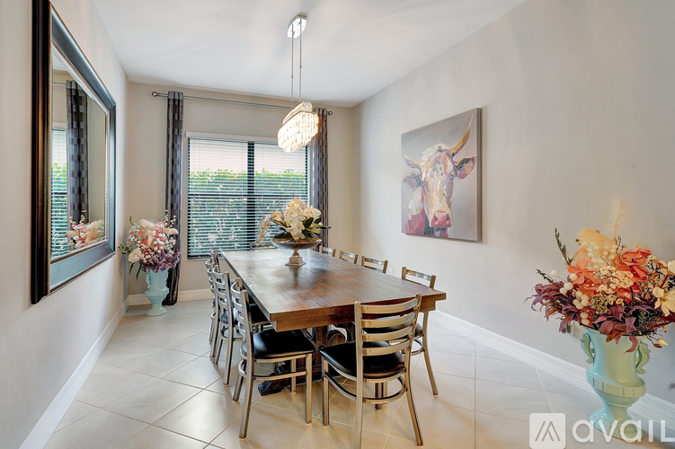 A dining room with a wooden table and chairs.