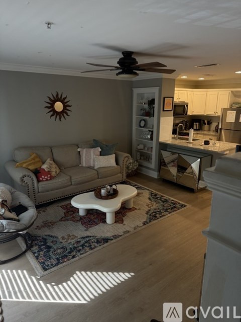 A living room with a grey sofa and a coffee table in the middle.