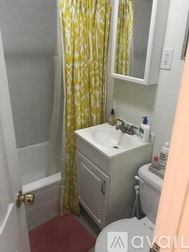 A small bathroom with a sink, toilet and shower.