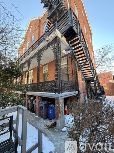 A building with a balcony and a staircase leading to the second floor.
