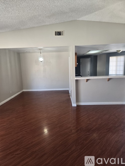 A room with wooden flooring and a white ceiling.