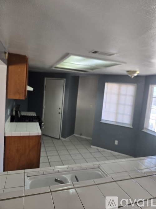 A kitchen with a sink and a window.