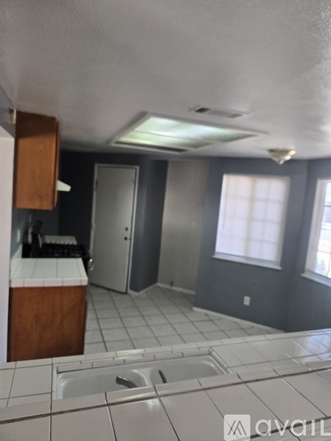 A kitchen with a sink and a window.