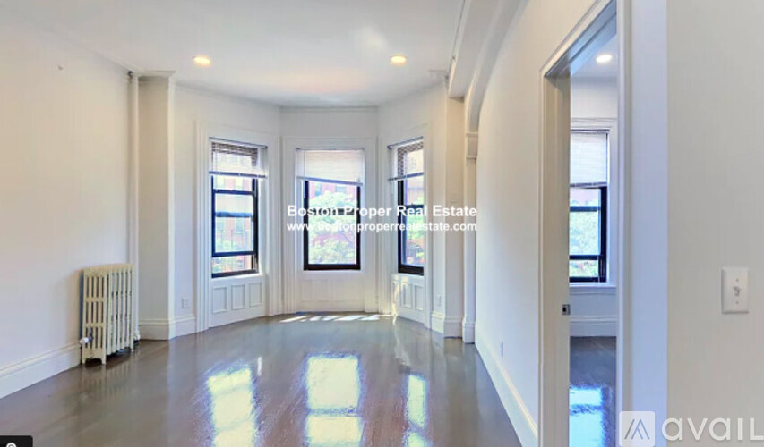 A spacious room with a radiator and a window.