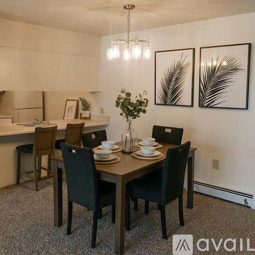 A dining room with a table set for two and two chairs.