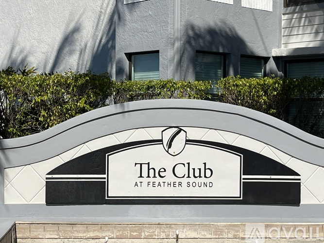 The Club at Feather Sound sign in front of a building.