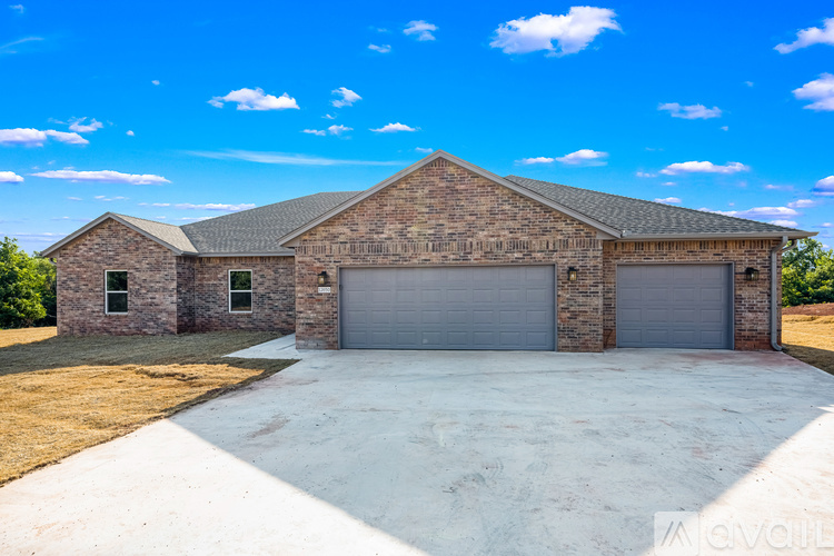 A large two-car garage with a brick exterior and a concrete driveway.