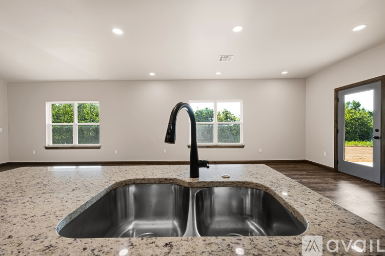 A modern kitchen with a double sink and a window.