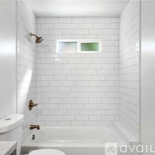 A white bathroom with a toilet, sink and bathtub.