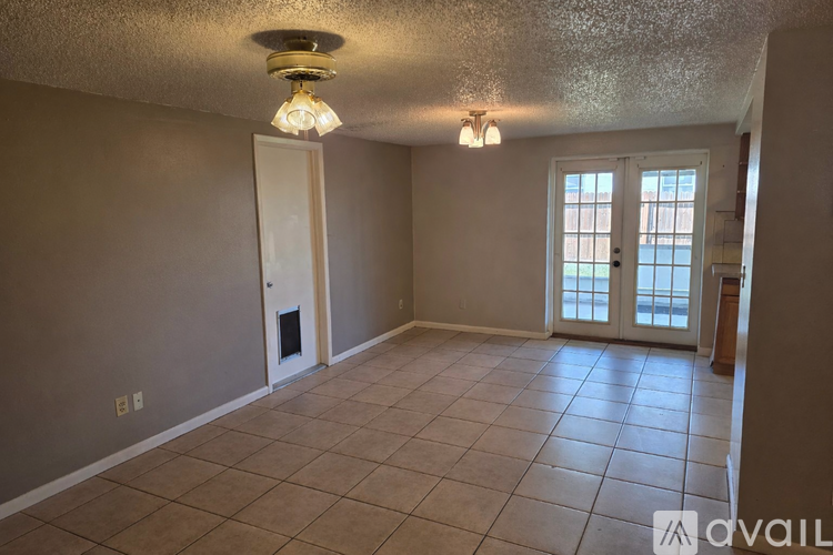 A room with a tile floor and a ceiling light.