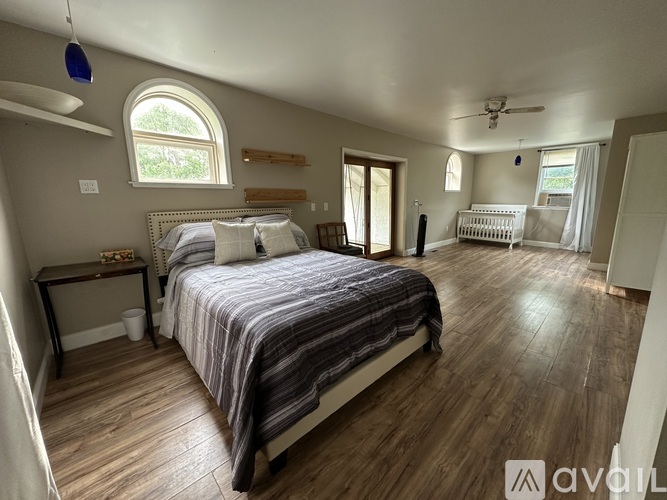 A bedroom with a large bed and a window.