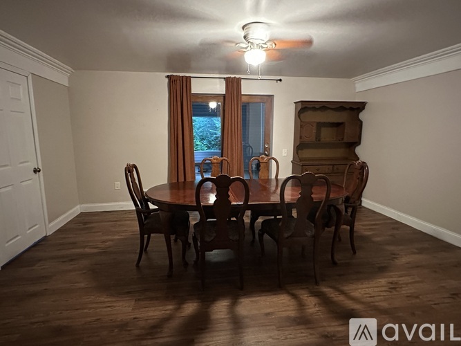 A dining room with a table set for six.