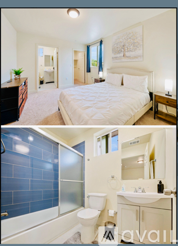 A bedroom with a large bed and a bathroom with blue tiles.