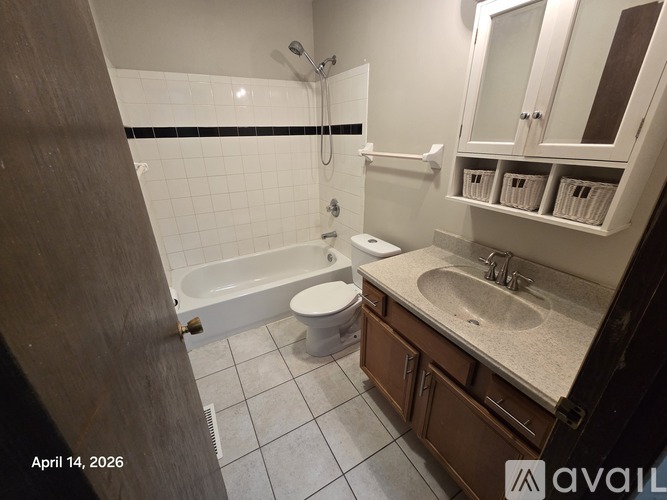 A bathroom with a white toilet, sink, and bathtub.