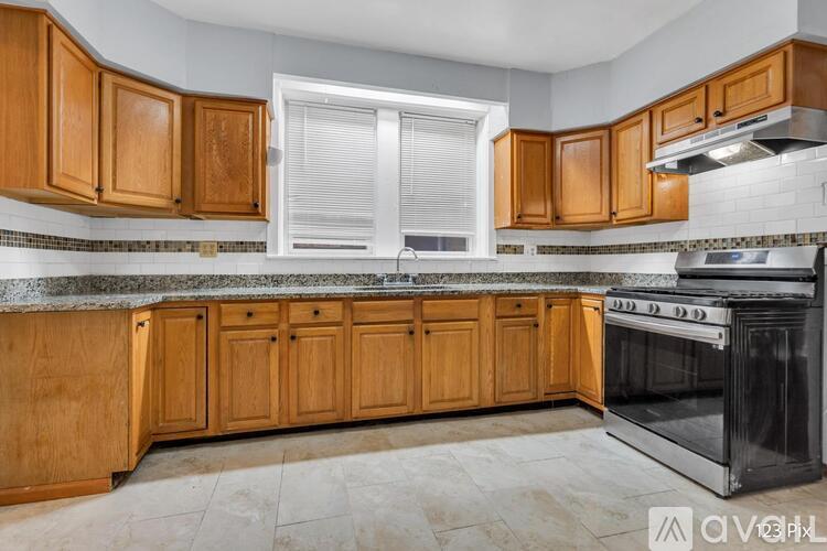 A kitchen with wooden cabinets and a black oven.