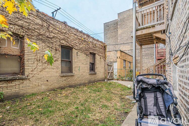 A backpack is placed on the ground in front of a building.