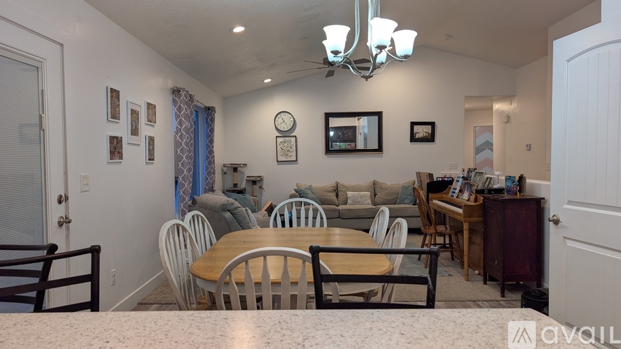 A dining room with a table set for six.