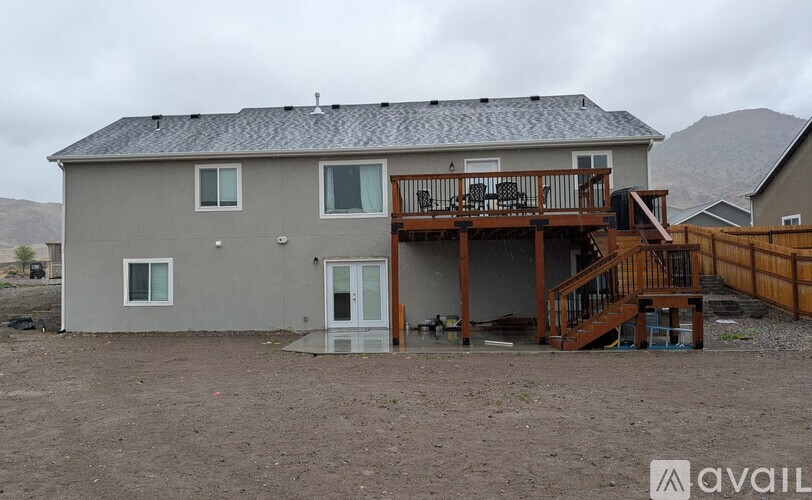 A house with a grey exterior and a brown deck.