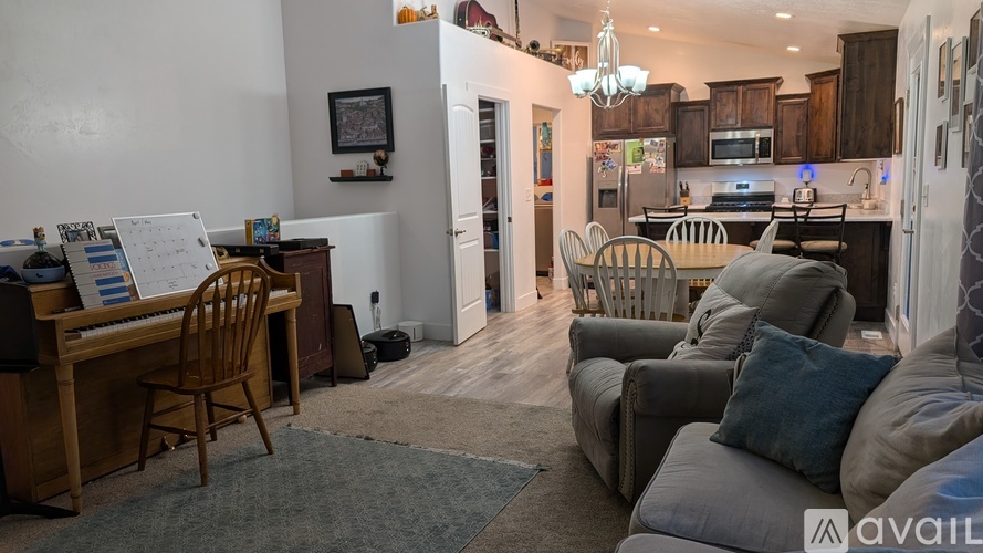 A living room with a piano and a couch.