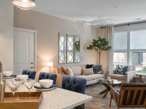 A modern living room with a blue sofa and a coffee table.