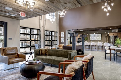 A living room with a brown leather chair and a green sofa.