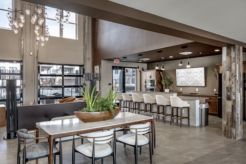A modern dining room with a long table and chairs.