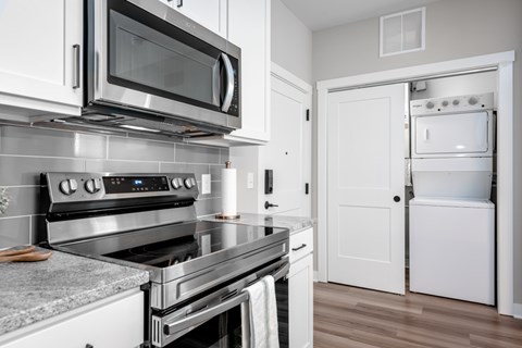 A modern kitchen with a stainless steel oven and microwave.