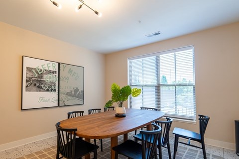 A dining room with a wooden table and chairs.