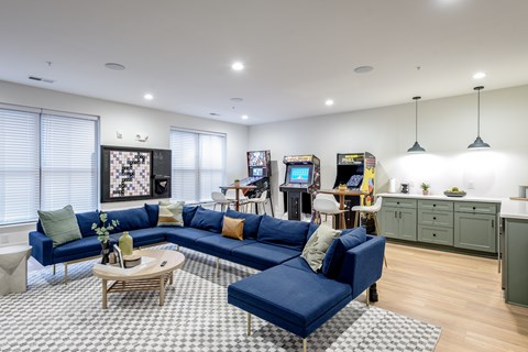 A living room with a blue sofa and a coffee table.