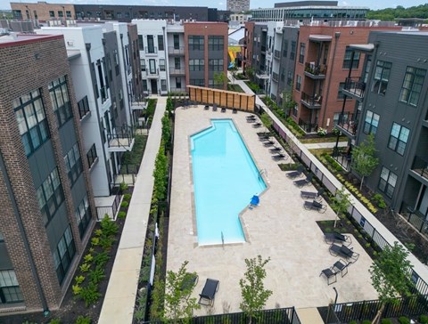 A swimming pool surrounded by apartment buildings.