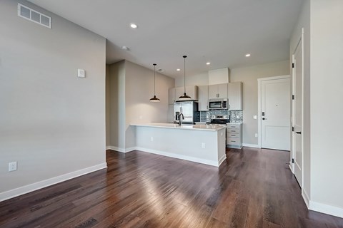 A kitchen with a white counter and a sink.