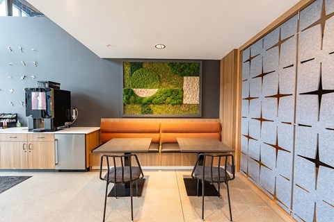 A modern kitchen with a wooden table and chairs.