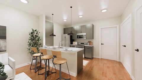 A kitchen with white cabinets and a wooden floor.