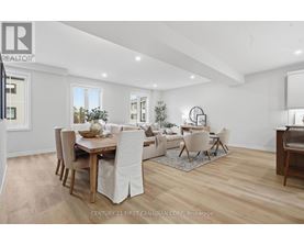 A spacious room with wooden flooring and white walls.