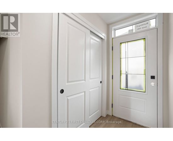 A white door with a window above it in a room.