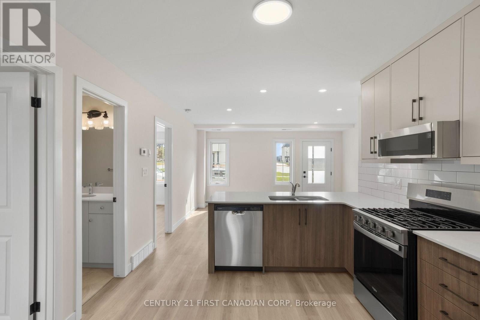 A modern kitchen with wooden cabinets and stainless steel appliances.