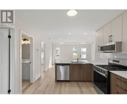 A modern kitchen with wooden cabinets and stainless steel appliances.