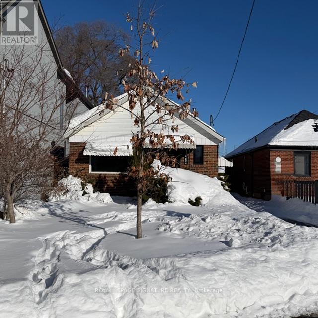 A house with a sign that says REALTOR in the foreground.