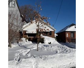 A house with a sign that says REALTOR in the foreground.