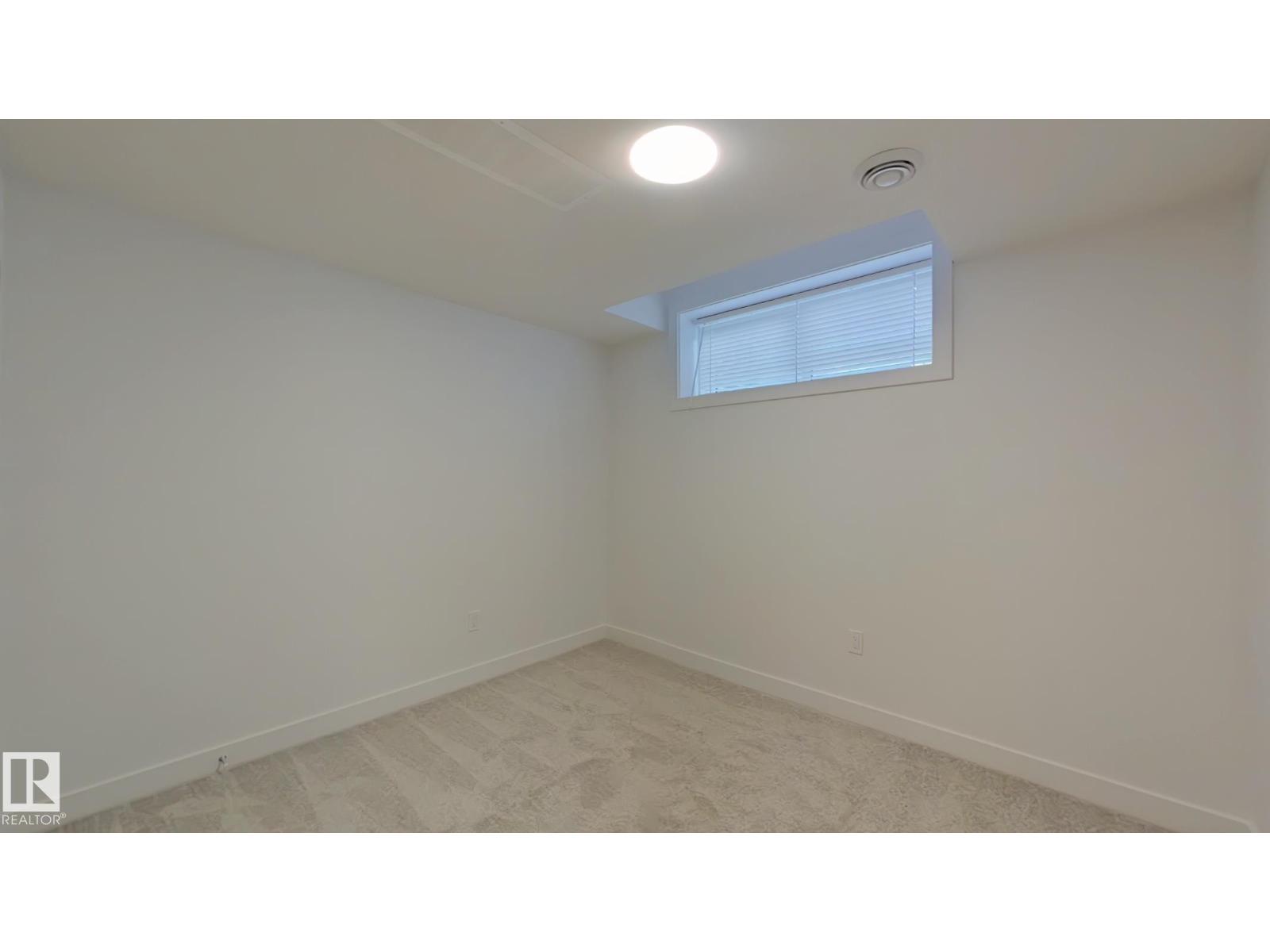 A room with a window and a ceiling light.