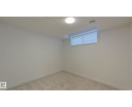 A room with a window and a ceiling light.