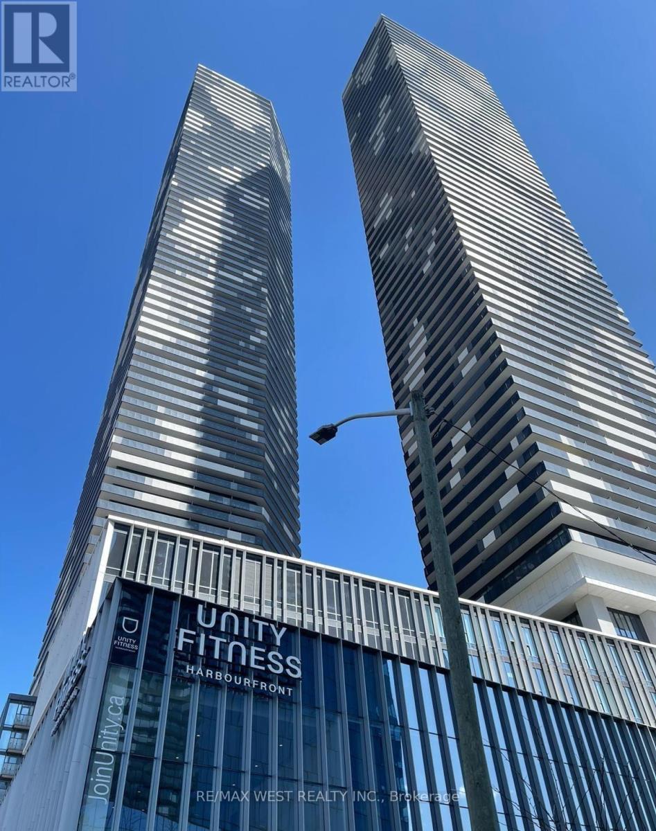 Two tall buildings with a sign that says "Unity Fitness" on the front of one of them.