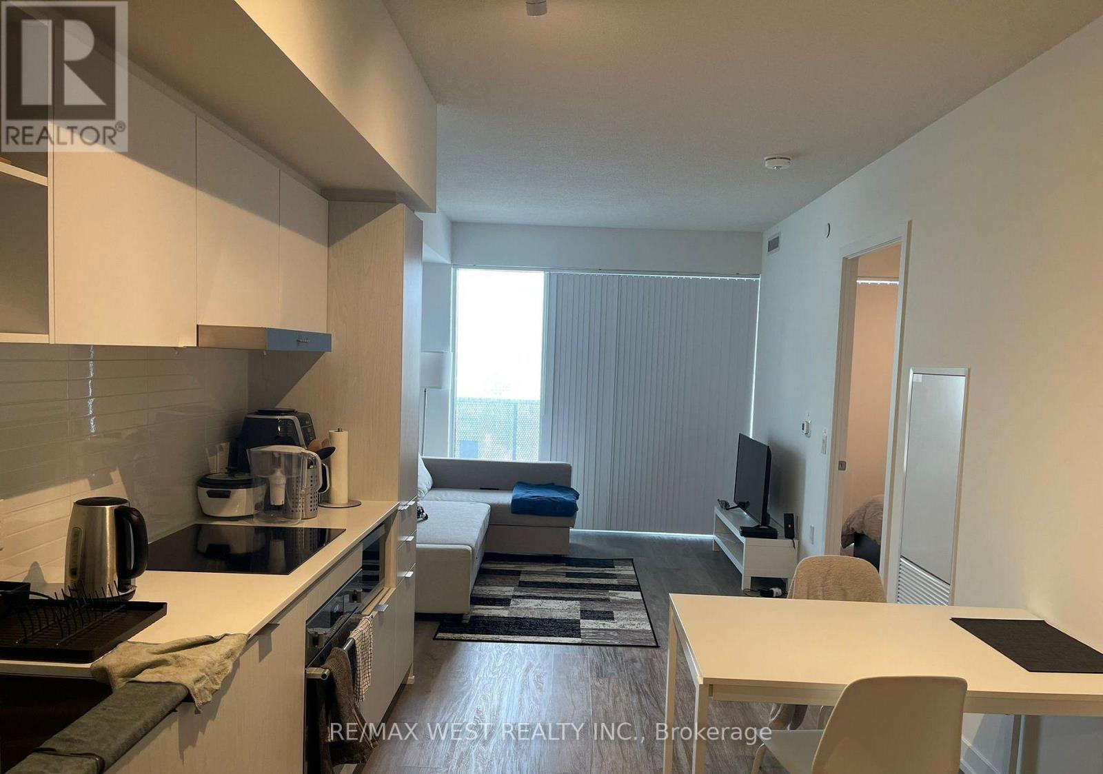 A kitchen with a table and chairs in the middle of the room.