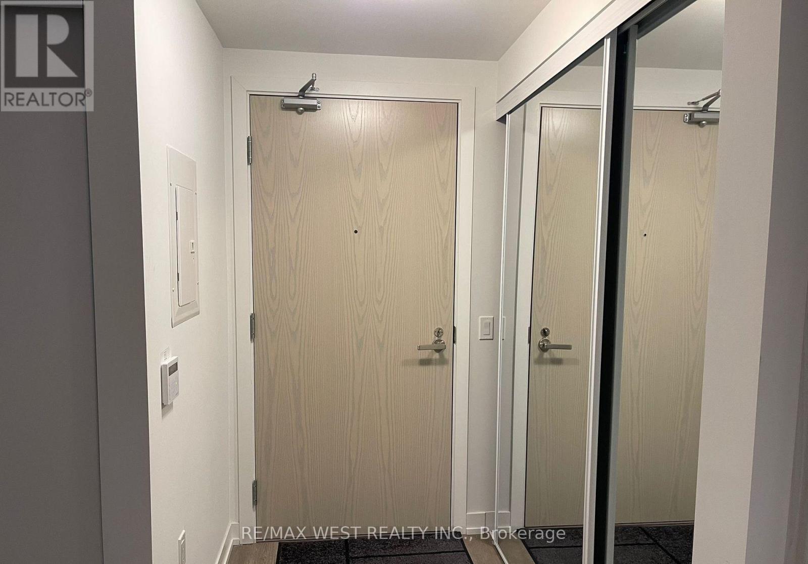 A brokerage office with a door and a sign on the wall.