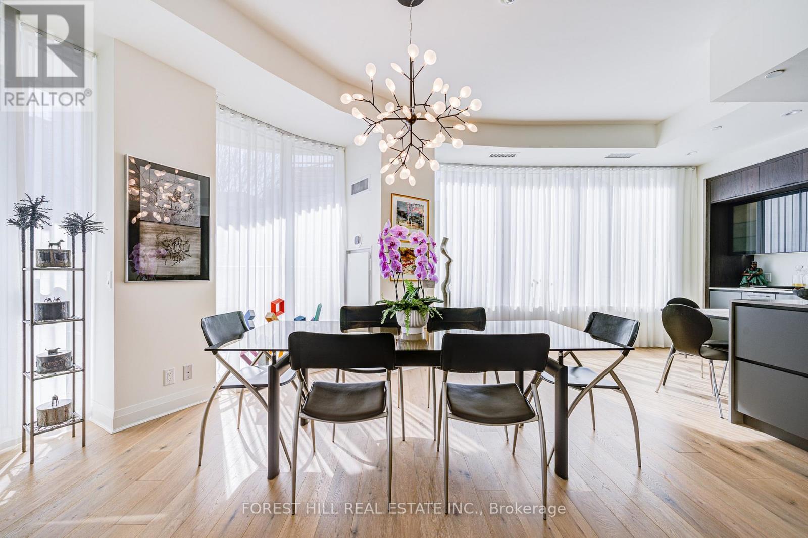 A dining room with a table set for six.