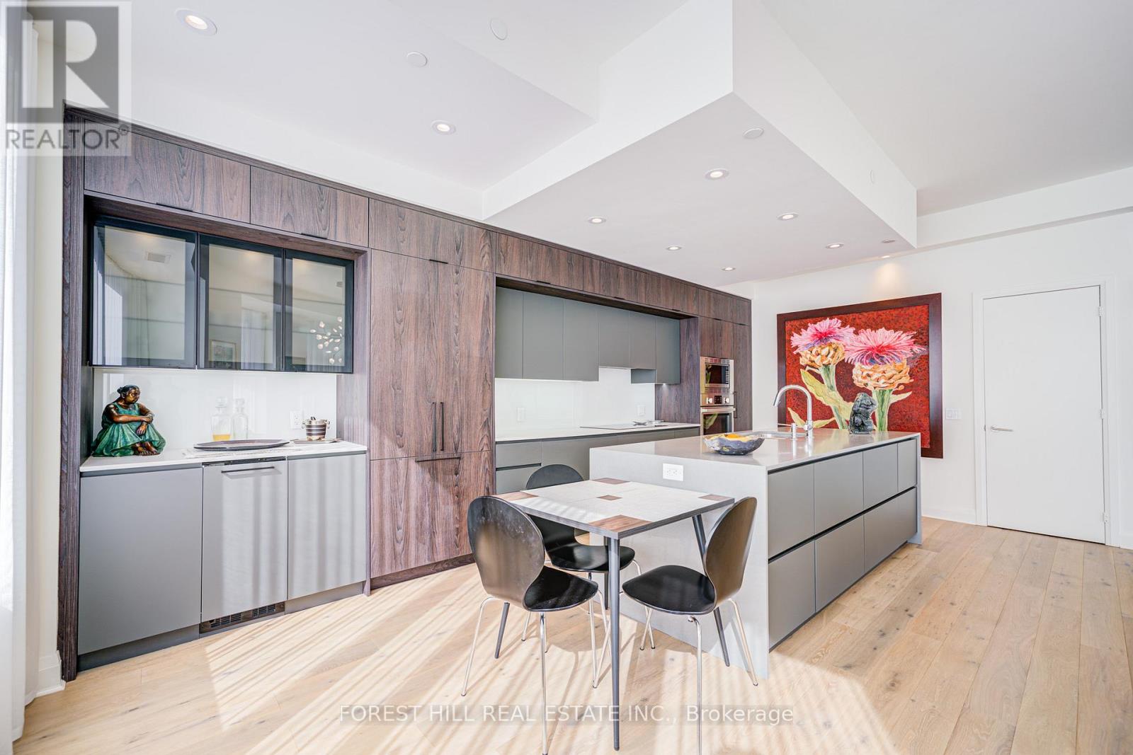 A modern kitchen with a dining table and chairs.
