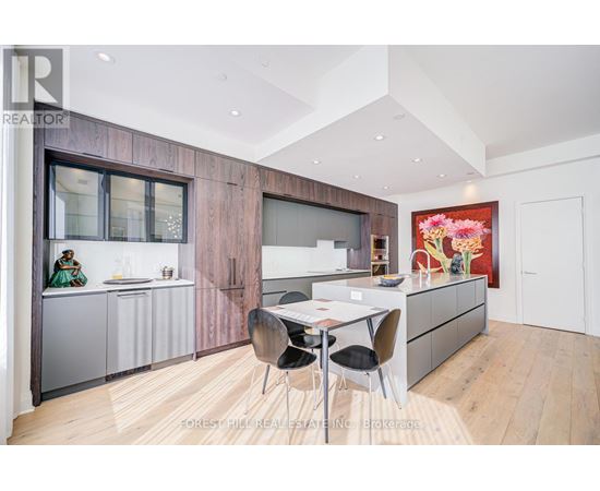 A modern kitchen with a dining table and chairs.