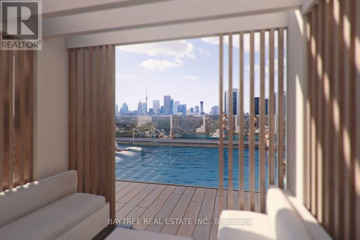 A view of a city skyline from a balcony with a pool.